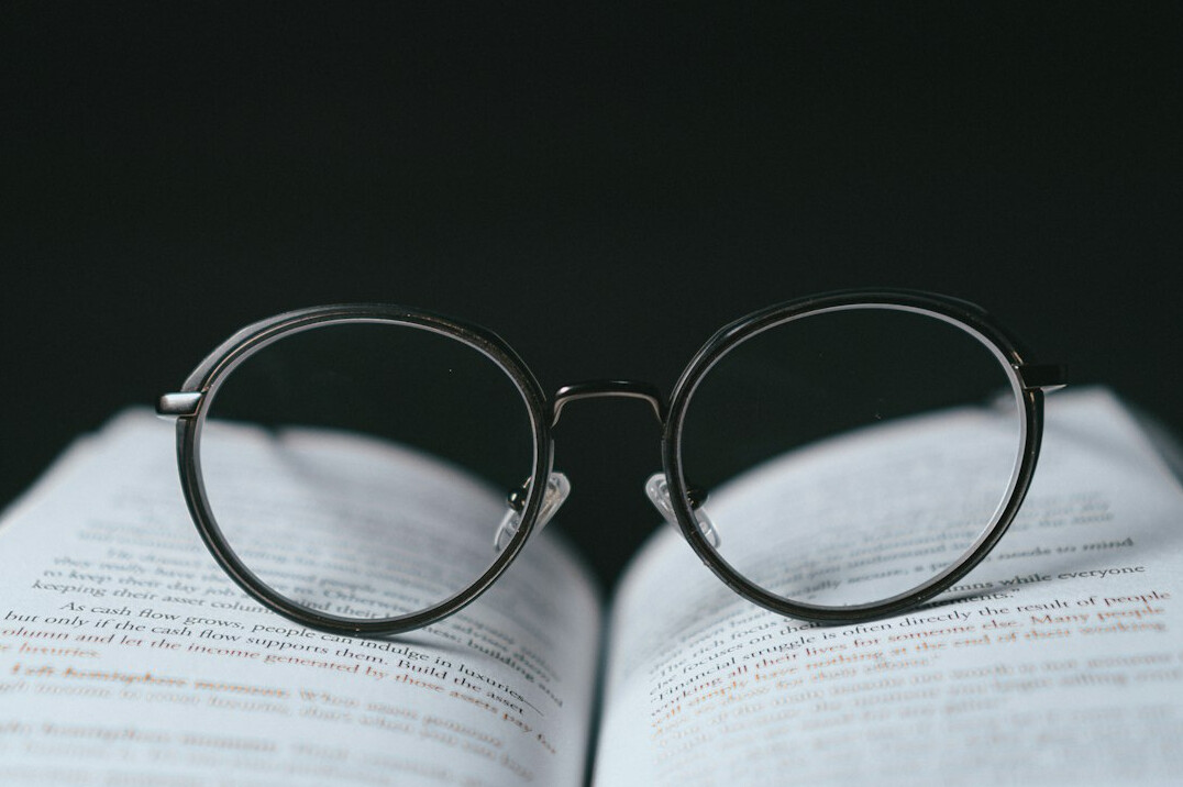 open mystery book with glasses