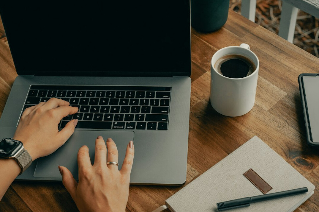 writer typing on laptop at desk